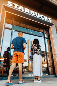 Rear view of people looking at entrance