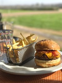 Close-up of burger and french fries on table