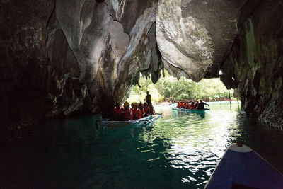 Group of people on rock in cave