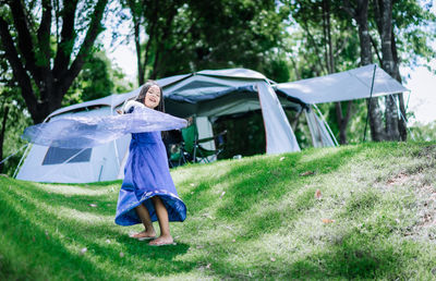 Woman standing in tent on field