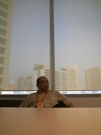 Portrait of man sitting on table