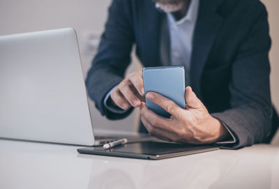 Midsection of man using laptop