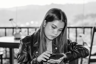 Close-up of young woman using mobile phone