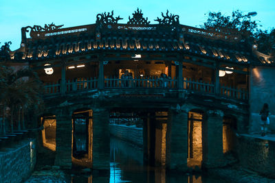 Low angle view of illuminated building against sky at dusk