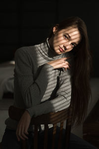 Portrait of a young woman sitting on chair