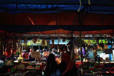 Rear view of women in hijab shopping at market