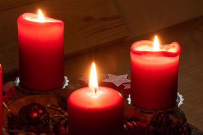 Close-up of illuminated tea light candles on table