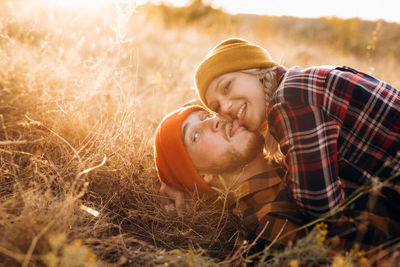 Portrait of young couple on field