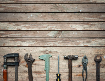 High angle view of hand tools on wooden table