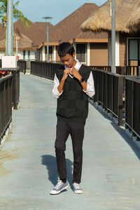 Portrait of young man standing in city