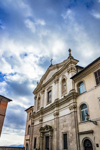 Low angle view of building against cloudy sky