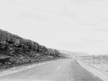 Empty road along trees