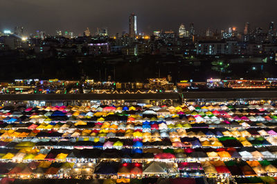 Illuminated cityscape against sky at night