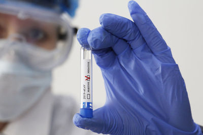 Close-up of woman holding test tube