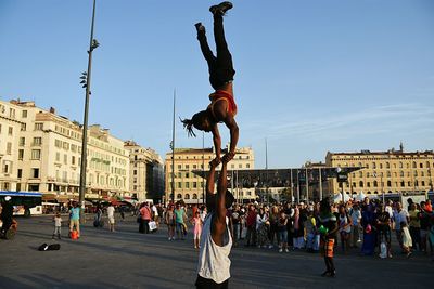 People in city against sky