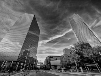 Low angle view of modern buildings against sky in city