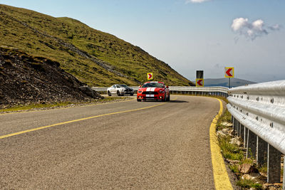 Cars on road against sky