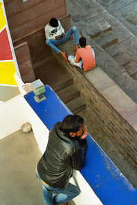 High angle view of people sitting on floor