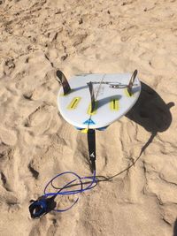 High angle view of surfboard at sandy beach