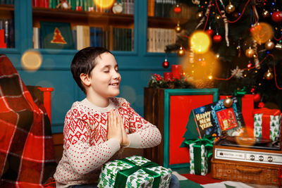 Cute boy lying down on the floor. kid making wishes for christmas.