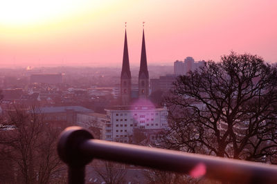 View of buildings in city at sunset
