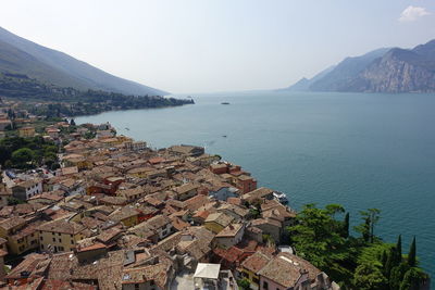 High angle view of townscape by sea against sky