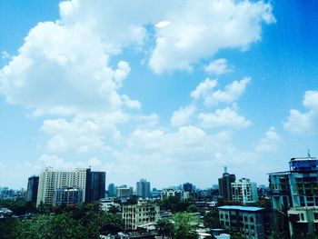 Buildings against cloudy sky