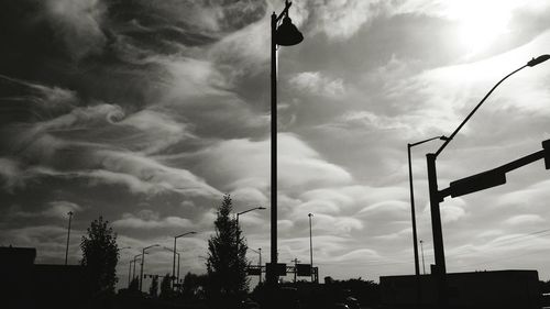 Low angle view of street light against cloudy sky