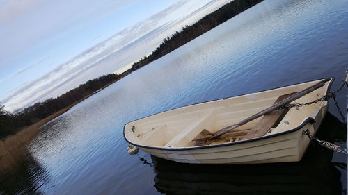 Boat moored on sea against sky