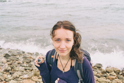 Portrait of woman standing on beach