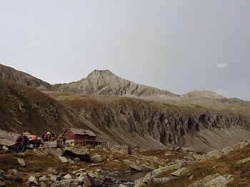 People on mountain against sky