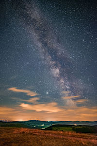 Scenic view of field against sky at night