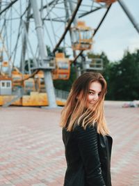 Portrait of smiling young woman standing outdoors