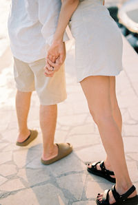 Low section of woman walking on floor