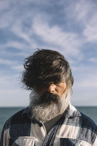 Close-up portrait of a man with tousled hair. hipster, urban, street style.