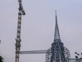 Low angle view of crane against sky