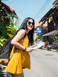 Young woman wearing sunglasses standing outdoors