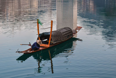 Man sitting in boat on lake