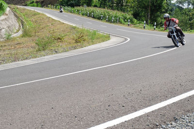 Man riding bicycle on road