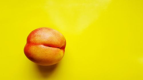 Close-up of apple against yellow background