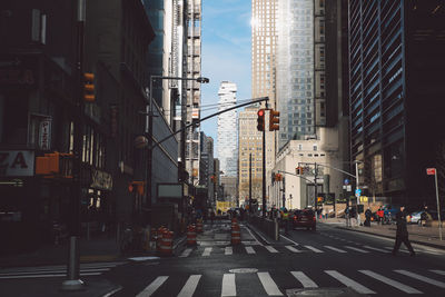 Zebra crossing on city street amidst modern buildings