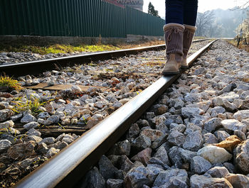 Low section of man standing on railway tracks