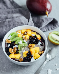 High angle view of chia pudding with fruits slices on table