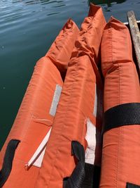 High angle view of life jackets on boat in lake