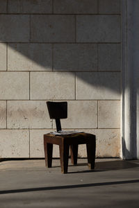 Empty chair in sunlight with shadow