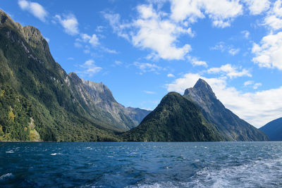 Scenic view of sea and mountains against sky