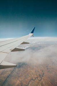 Aerial view of airplane wing over landscape