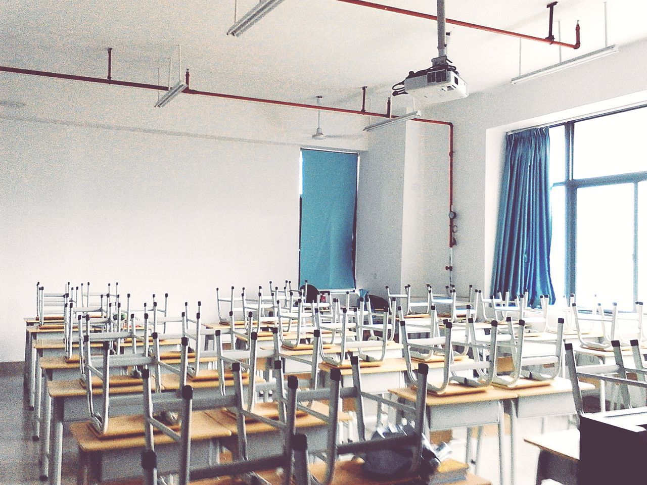 chair, table, absence, empty, indoors, group of objects, built structure, day, window, architecture, restaurant, arrangement, no people, in a row, blue, wood - material, sunlight, side by side, moored, seat