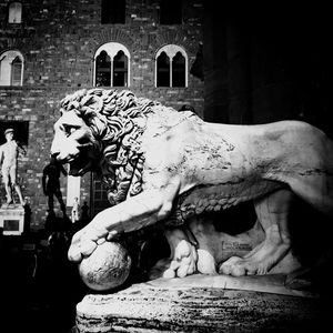 Statue against historic building