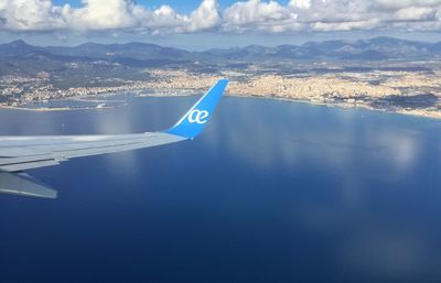 Aerial view of sea and mountains against sky